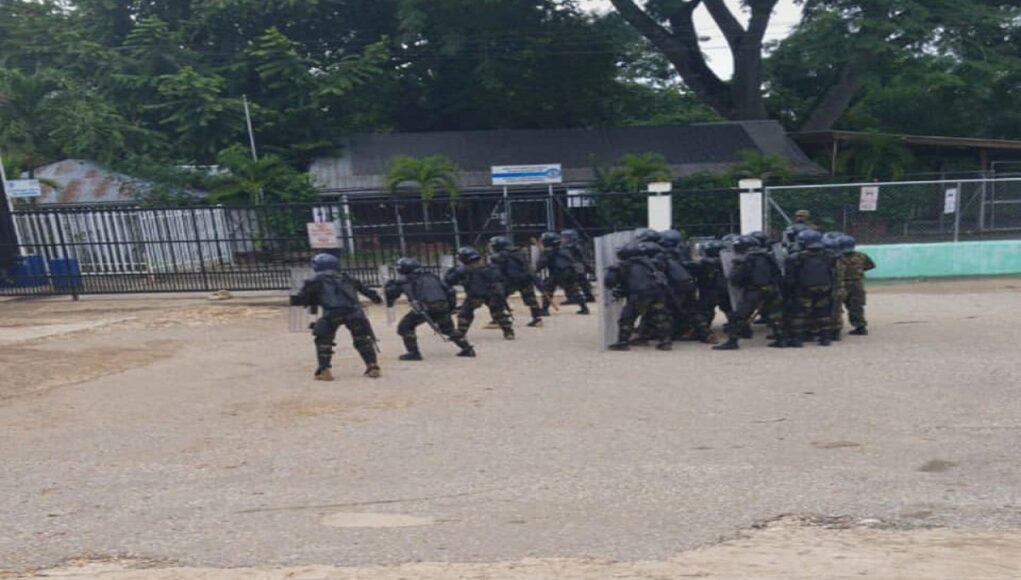 Soldiers with riot gear are on the ground at the Western Border 1